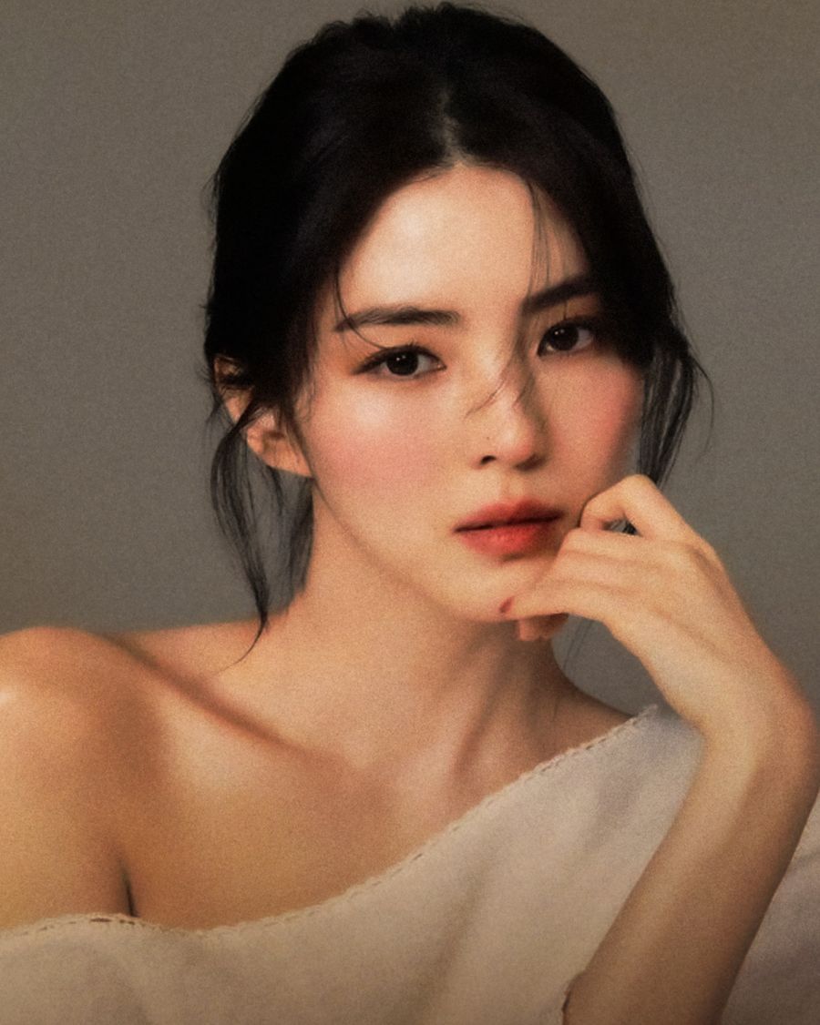 Portrait of a woman with softly styled, glossy dark hair.